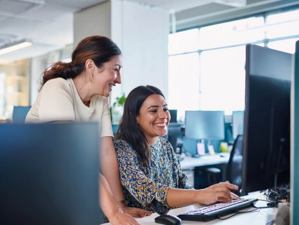 Two women working on computer